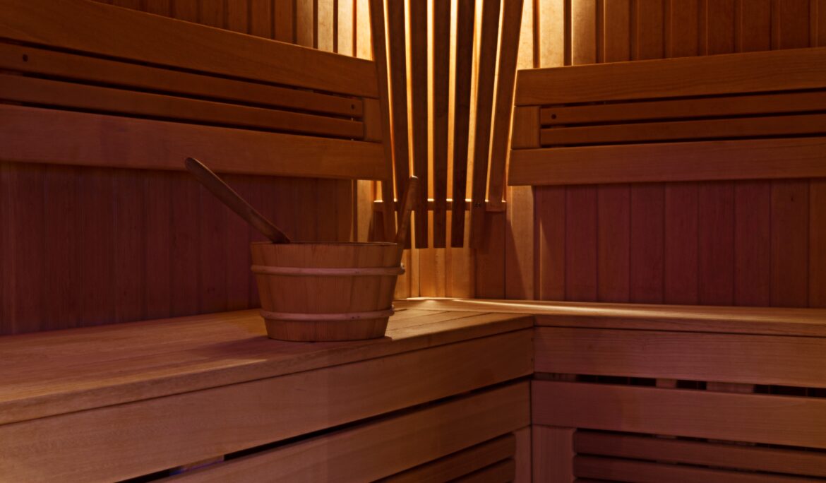 Dubai wooden corner sauna design | Compact L-shaped wooden sauna with horizontal tongue-and-groove paneling