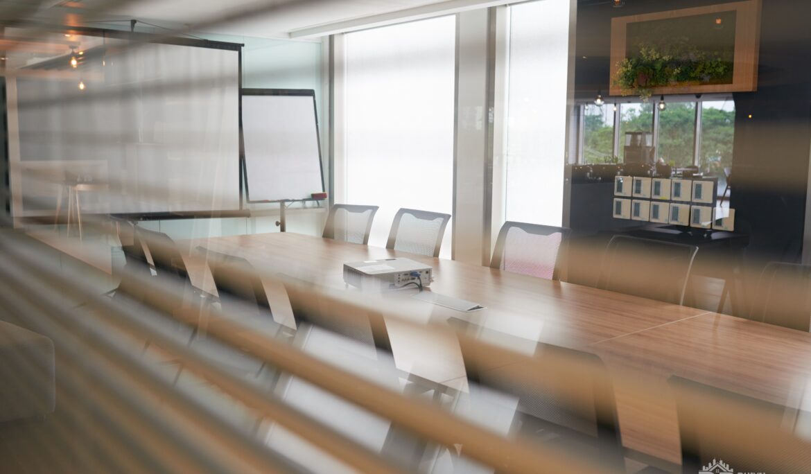 Dubai modern glass conference room by DubaiRenovate featuring a long light-wood table