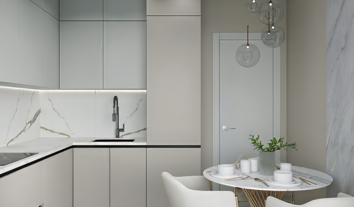 Compact Dubai kitchen dining nook | Compact L-shaped Dubai kitchen dining nook with matte cream handleless cabinets