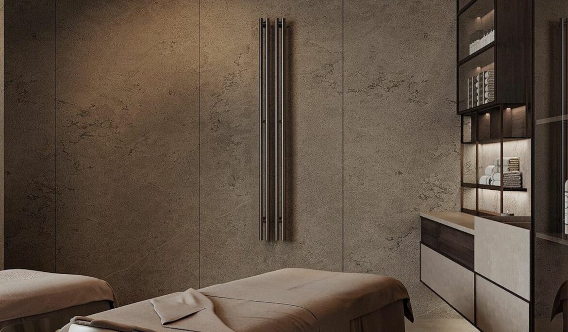 Dubai minimalist luxury spa design Central massage | Dimly lit Dubai spa treatment room with two skirted massage beds