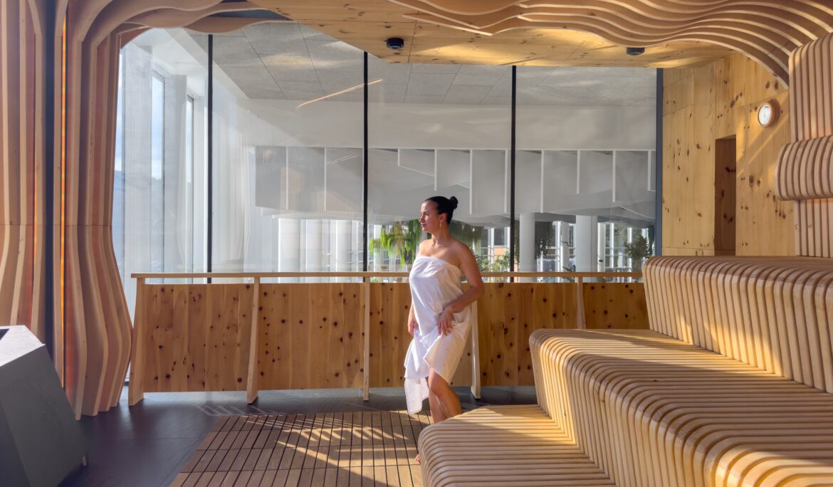 Dubai wooden wave sauna interior by DubaiRenovate with warm slatted timber and full-height glazing